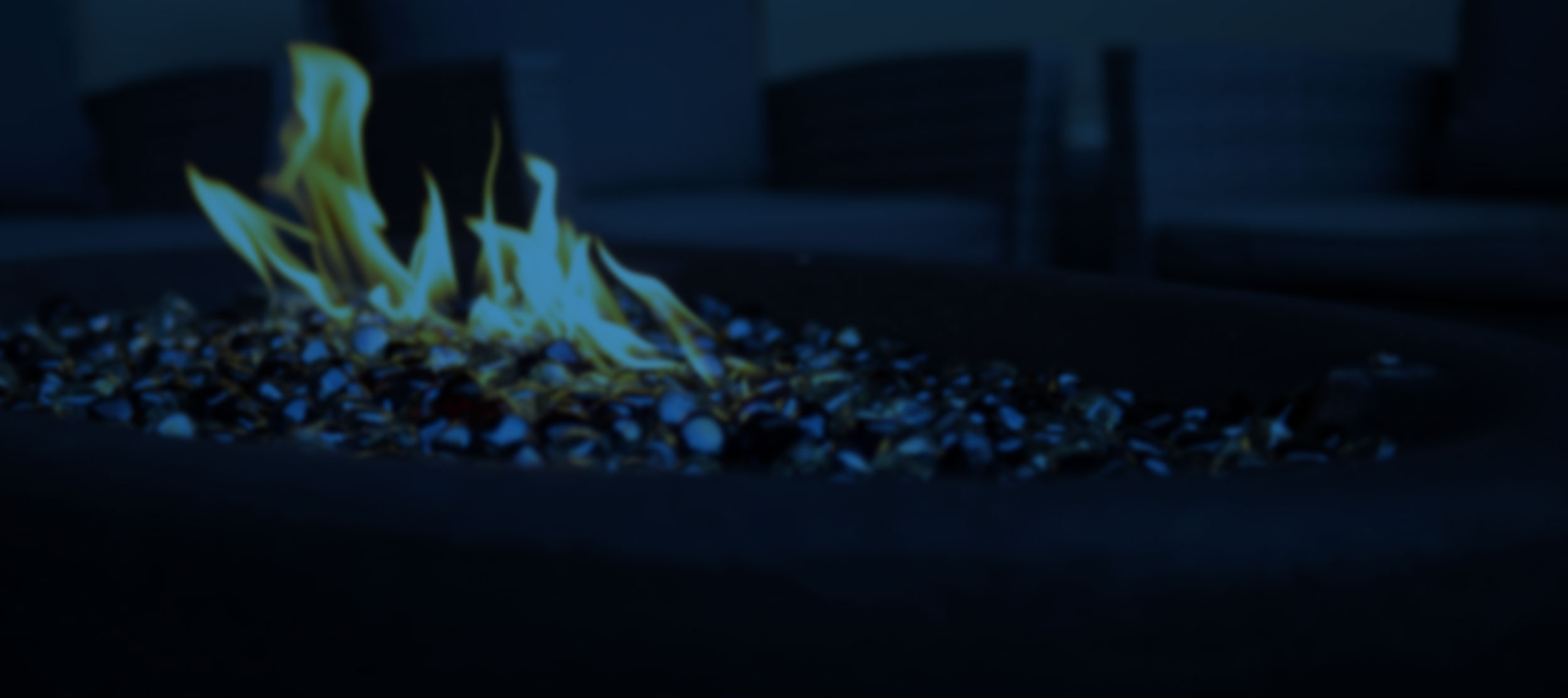 outdoor firepit table lit at dusk