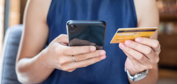 woman making propane service payment on mobile phone