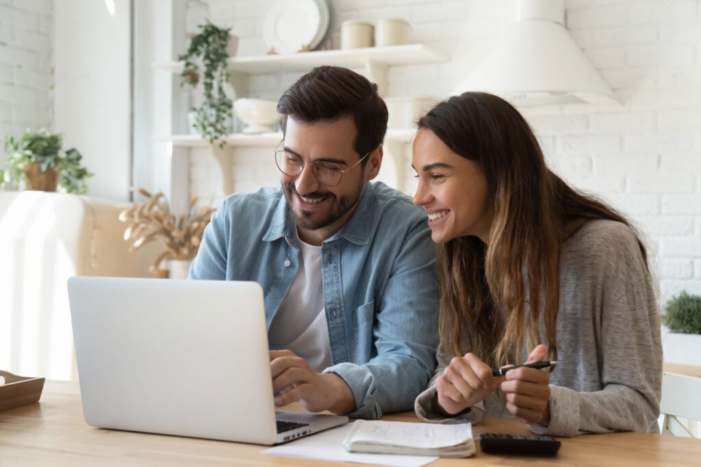 happy couple paying bills online