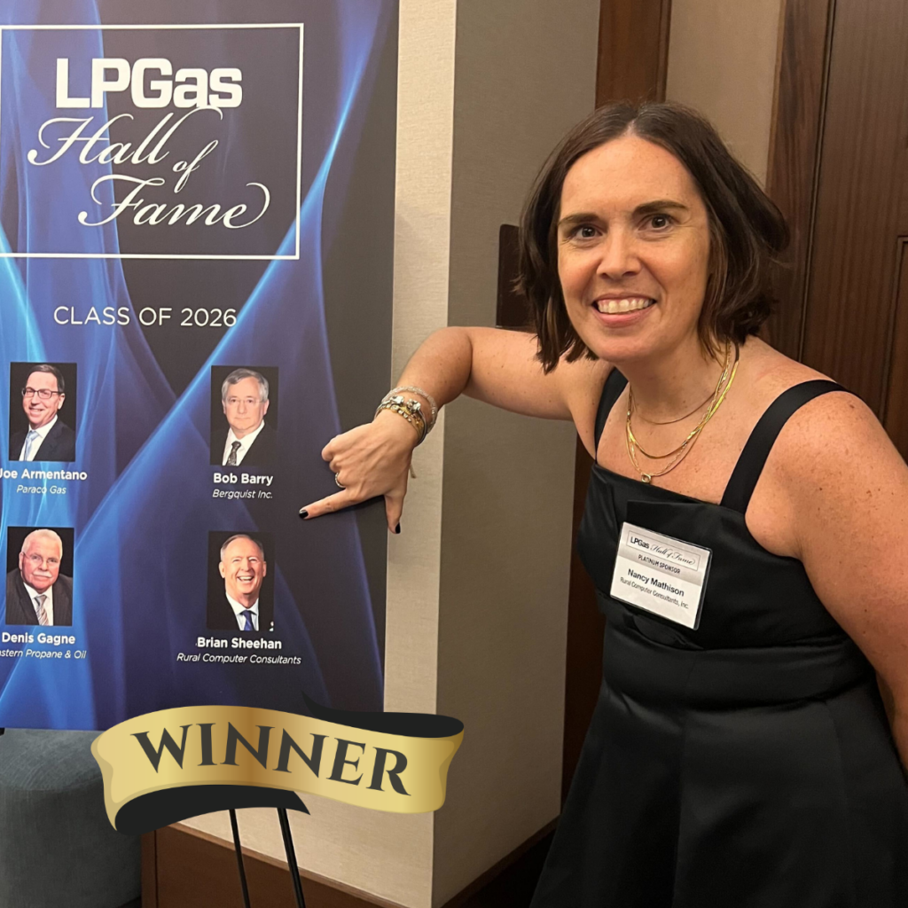 Woman in a black dress points to LP Gas Hall of Fame Class of 2026 poster with WINNER graphic at the bottom.